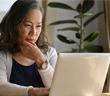 A neurodivergent person using a laptop