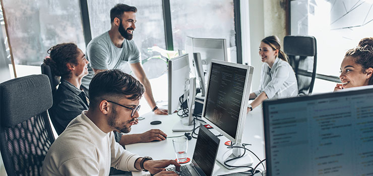 People working in an office using the latest software solutions