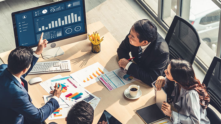 A group of people at working using software from Converge UK