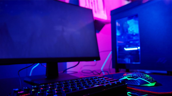 An esports gaming PC with keyboard, mouse and moody lighting