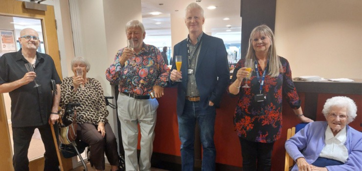 Converge employees showcasing technology to elderly members of the community