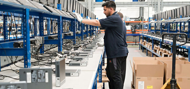 A member of Converge building IT devices at Granite One Hundred in Stafford for customers