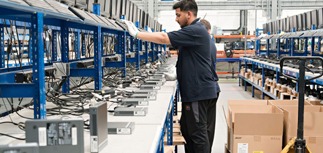 A member of Converge building IT devices at Granite One Hundred in Stafford for customers