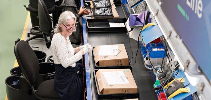 A Converge member of staff working at the IT build line