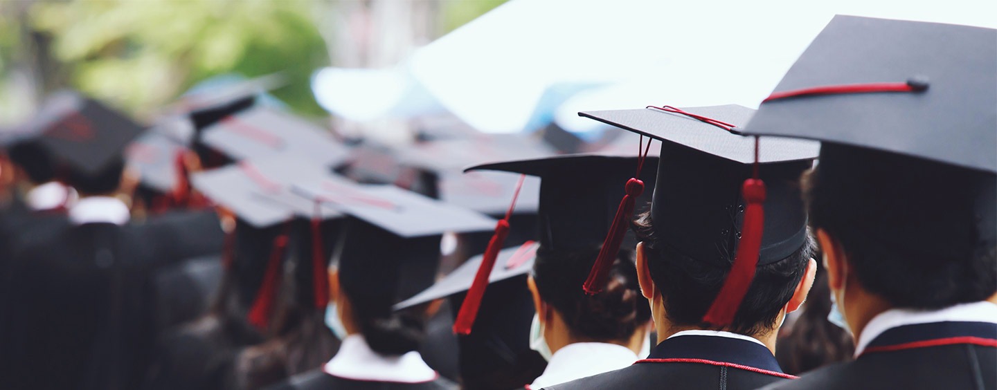 Student dressed in graduation outfits