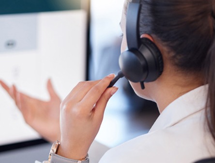 A customer service agent discussing services with as customer over the phone