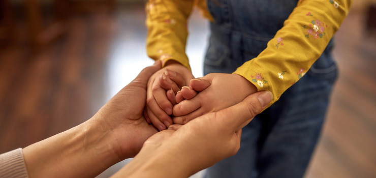 A mother and daughter holding hands