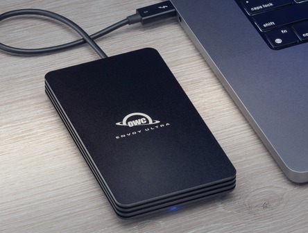 A portable storage device from OWC plugged into a laptop
