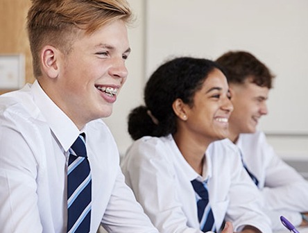 Secondary School children in uniform learning in class