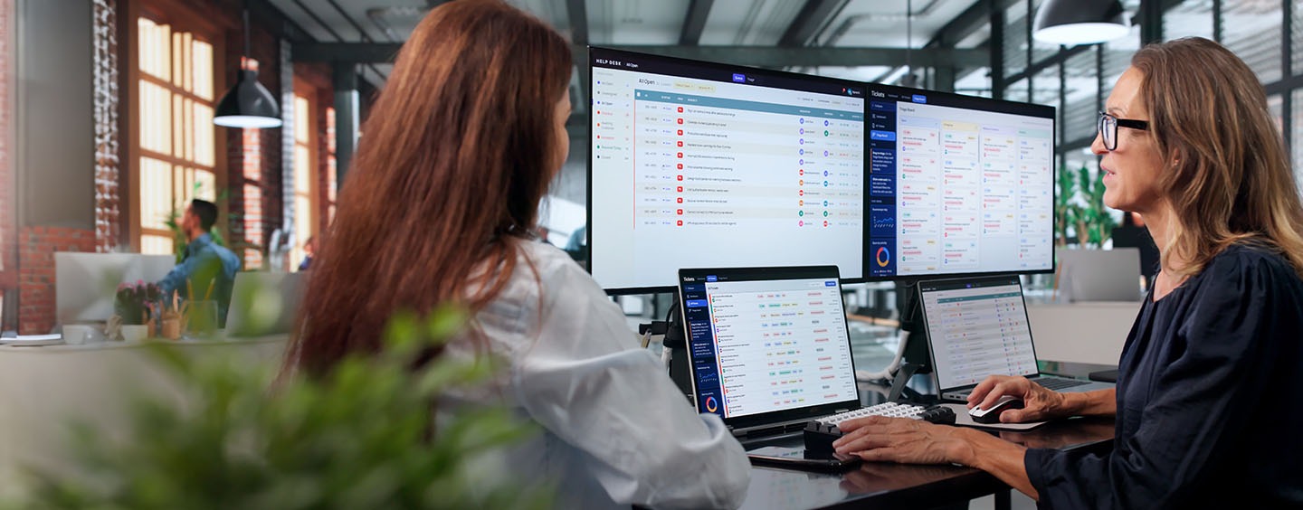 A person working at a computer managing a customers IT solutions