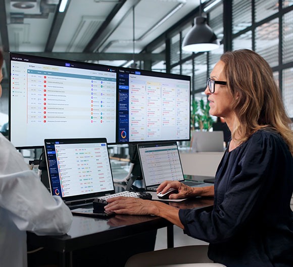 A person working at a computer managing a customers IT solutions