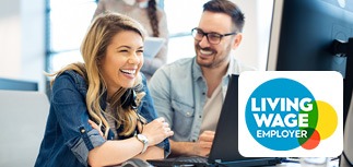 Photo showing a man and woman in from of a computer monitor