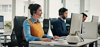 A woman at a desk working on a sustainable computer