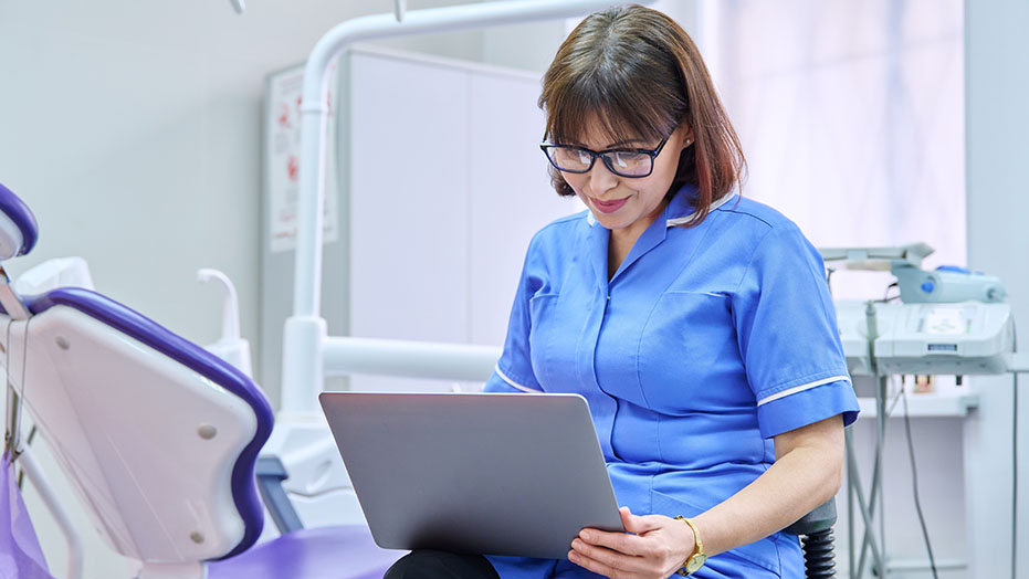 A Nurse using a tablet to conduct patient research.